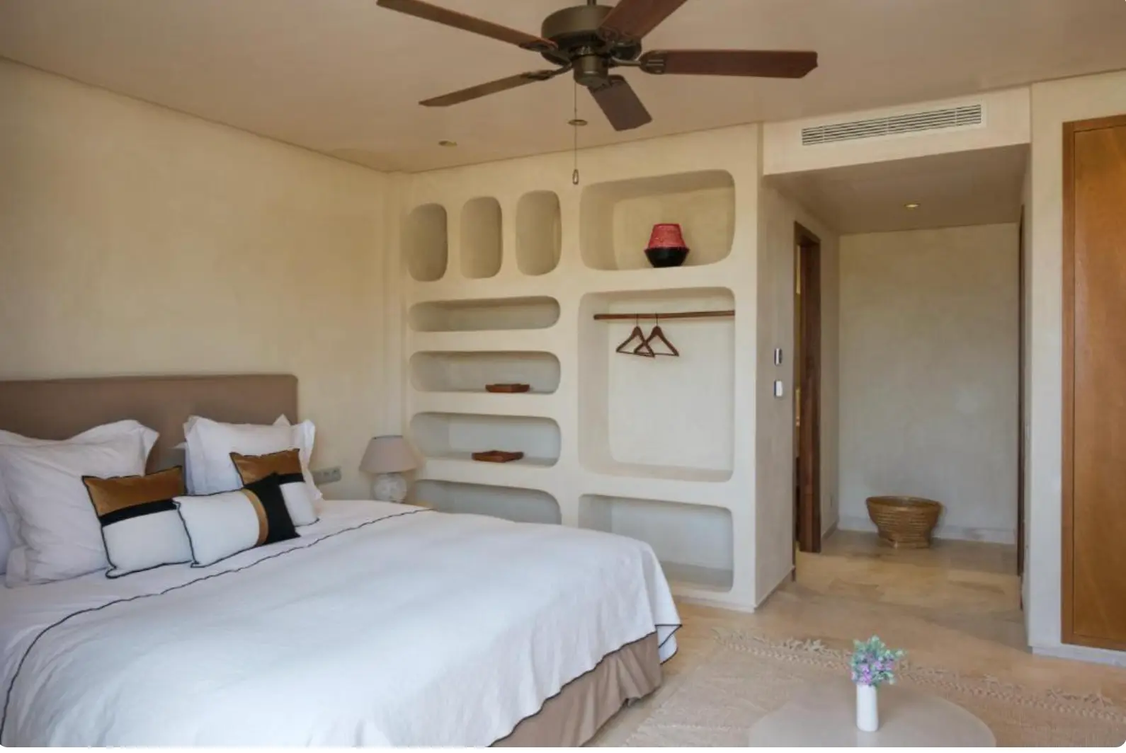 Villa Sama double bedroom with white bedding and sculpted wall niches